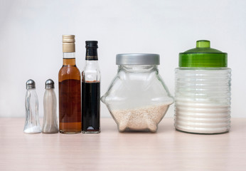 Obraz na płótnie Canvas jar of rice, a jar of sugar, bottles of sauce and vinegar, salt, pepper