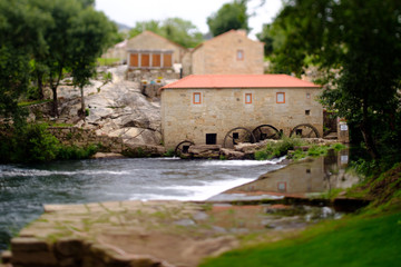 Obraz premium A picture with a Tilt and shift lens of a mill-house in Vilar de Mouros, Portugal.