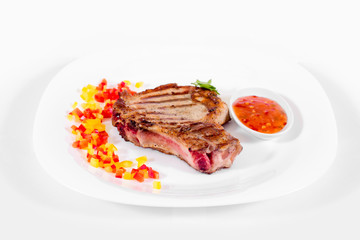Steak on a plate on a white background