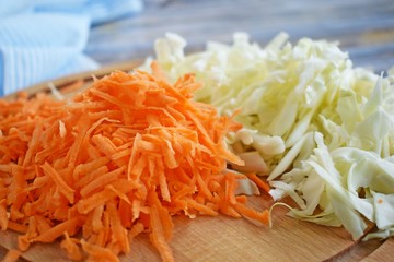 Sliced carrots and cabbage on a wooden Board.Food ingredient.
