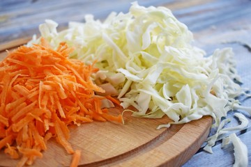 Sliced carrots and cabbage on a wooden Board.Food ingredient.