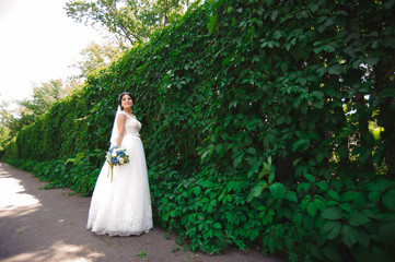 Beautiful bride outdoors in a forest.