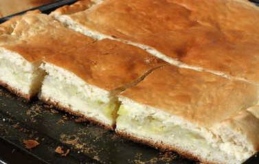 Cabbage pie freshly baked, sliced on baking tray