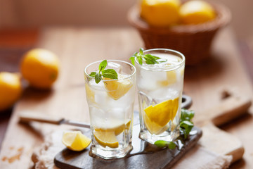 Refreshing summer drink with lemon, mint and ice copy space