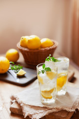 Refreshing summer drink with lemon, mint and ice copy space