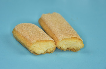 Ladyfinger biscuits (savoiardi),piscoturi, on blue  background