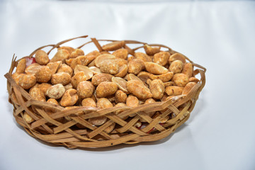 Spicy peanuts,hazelnuts in a wicker basket