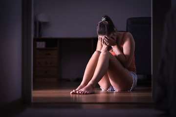 Lonely young woman worrying. Sad girl crying and having emotional breakdown, burnout, crisis, pressure or stress. Ashamed teenager with guilt or embarrassment. Victim of bullying or abuse.