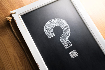 Question mark drawn on chalkboard.  About us, help or info for business. Survey, poll or quiz...