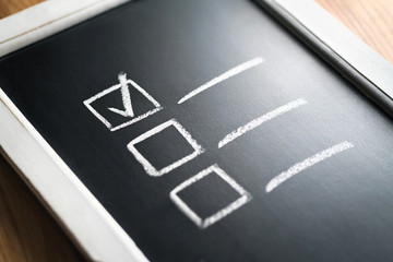 Checklist on chalkboard. Agenda and progress of project in business. Document of finished work...