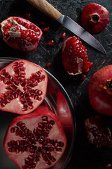 Flat lay with garnets in metal bowl and knife
