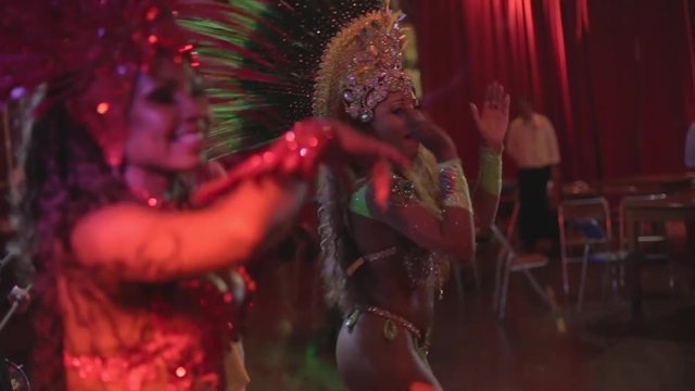 Pair of Brazilian samba dancers dancing side by side and clapping