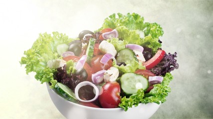Close-up photo of fresh salad with vegetables in white plate