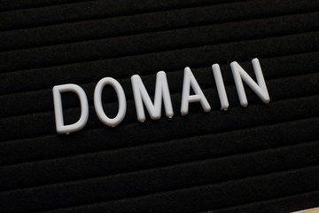 The word Domain in white plastic letters on a felt notice board
