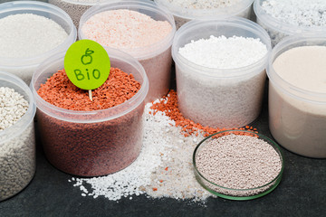 heap of red fertilizer in jar. Nitrogen (N): leaf growth,Phosphorus (P): Development of roots,Potassium (K): Strong stem growth