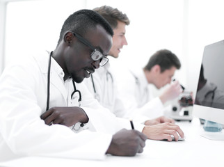 group of doctors sitting in the laboratory