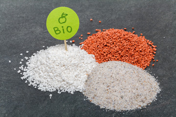Mineral bio fertilizers with green plate, close-up view