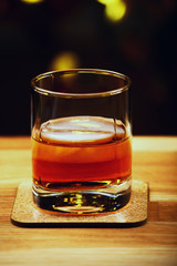 ice whiskey glass gold bokeh 
