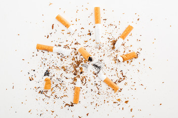 Studio shot of cigarette butts and tobacco isolated on white, stop smoking concept