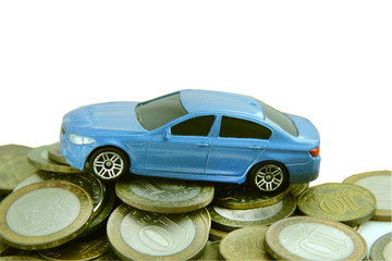 Blue Car On A Pile Of Coins 