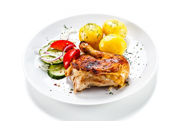 Grilled chicken leg with vegetables on white background