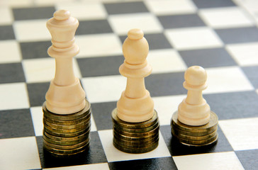 Chess and stack of coins in concept of money power or saving money,  business finance wealth and success, financial growth