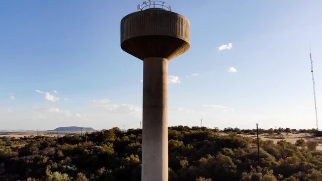 DRONE Reveal Shot of a Broadcast Tower in a Rural Area on a Sunny Day