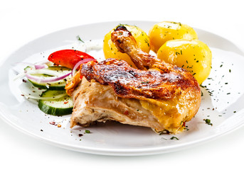 Grilled chicken leg with vegetables on white background