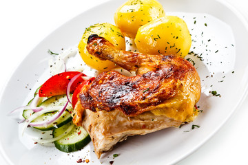 Grilled chicken leg with vegetables on white background