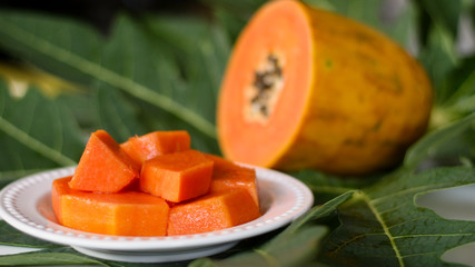 Papaya fruit on leaf background.