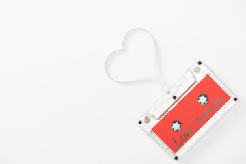 top view of audio cassette with 'love songs' lettering and heart symbol isolated on white with copy...
