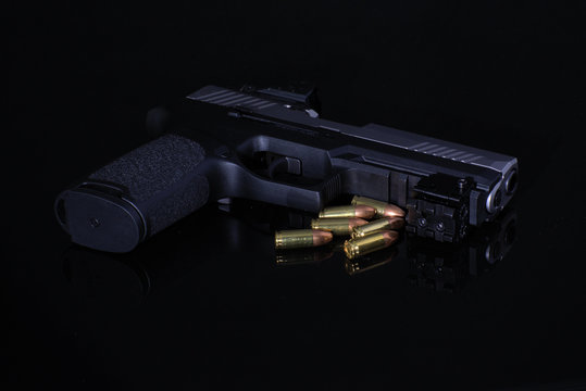 gun and bullets on black background
