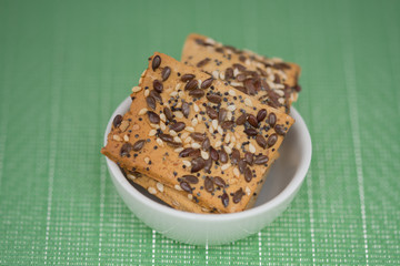  cookies with  poppy seeds and sesame seeds in a porcelain bowl