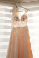 Wedding preparations - beautiful wedding dress on a custom hanger