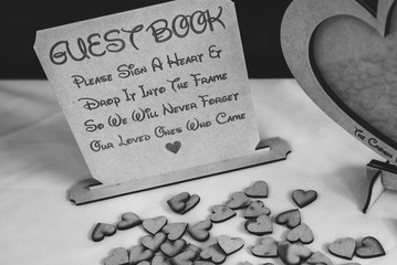A wedding guest book with wooden love hearts