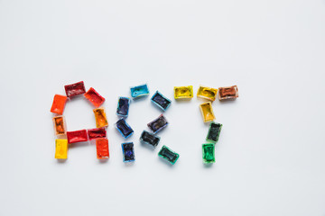 top view of art lettering made of paints on white background