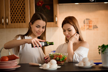 Friends prepearing brekfast and having meal in kitchen together.