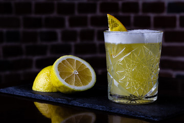 A classic recipe for whiskey sour - with bourbon, cane syrup and lemon juice, garnished with orange. Traditional aperitif. Space for text