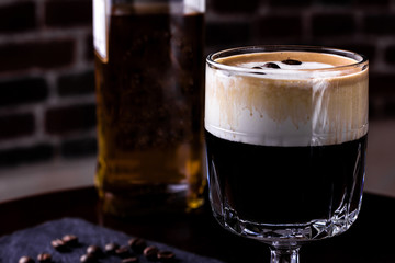 Irish coffee in a bar. Concept of St Patrick holiday. Holiday background. Irish national day. Warm tone. Square