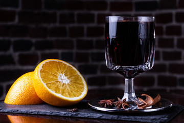 Glasses of delicious mulled wine on color table