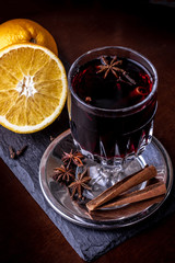 Glasses of delicious mulled wine on color table