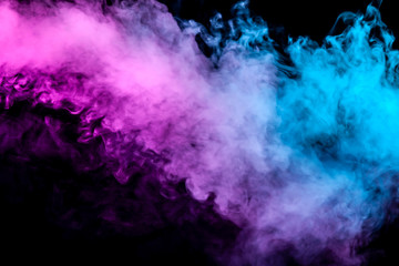 Naklejka na ściany i meble Translucent, thick smoke, illuminated by light against a dark background, divided into two colors: blue and purple, burns out, evaporating from a steam of vape.