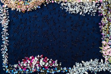 Beautiful shiny background. Crystals, beads, wire, twigs, wedding accessories collected on dark fabric