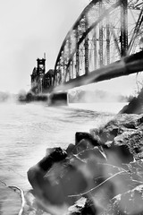 bridge over foggy river B&W