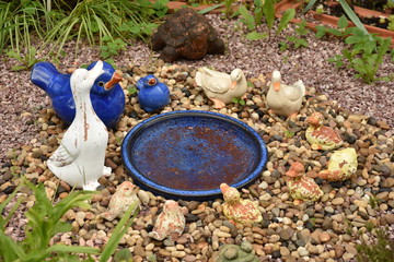 Arrangement of ceramic animals ,geese  in the garden ,in Germany