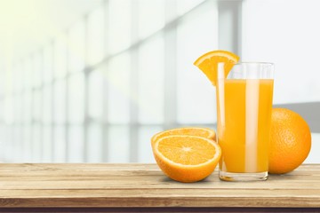 Glass of delicious orange juice on natural background
