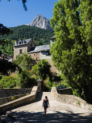 Girl walking through the village of Sallent de Gállego in the Spanish Pyrenees