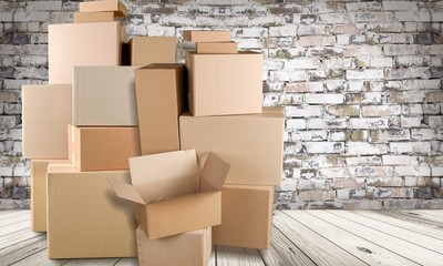 Different cardboard boxes in room on wooden floor