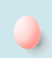 pink easter egg isolated on blue with clipping path