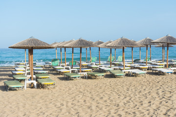 straw parasols on the beach of Falassarna, Crete